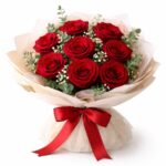Premium fresh red rose bouquet wrapped in elegant beige paper with satin red ribbon for romantic gifting