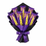 Luxury Cadbury Munch chocolate bouquet wrapped in matte black and royal purple paper with satin ribbon for gifting